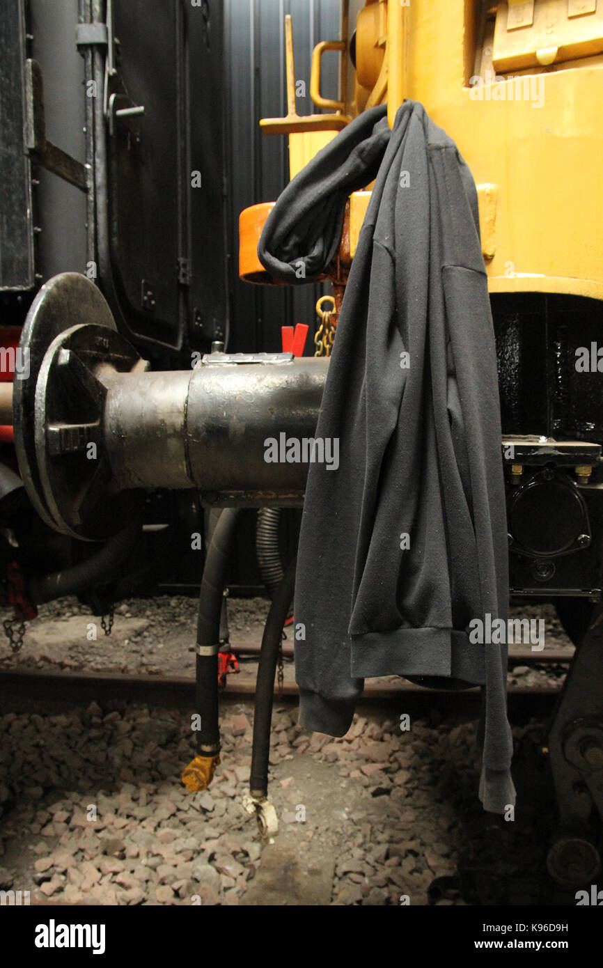 Jacket left hanging on railway carriage buffers during work break in ...