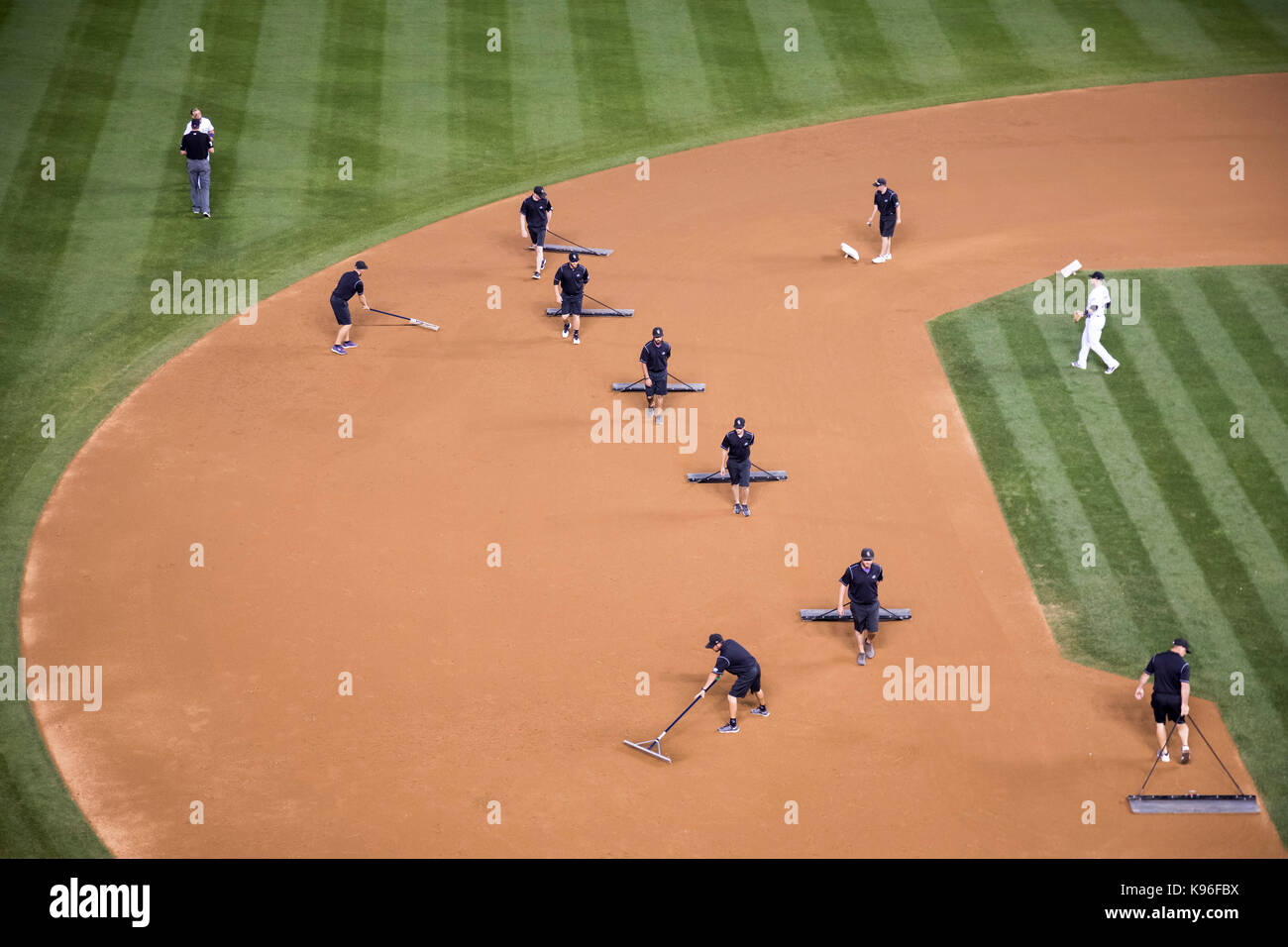 Denver, Colorado - The grounds crew grooms the infield between innings of a baseball game at Coors Field. Stock Photo