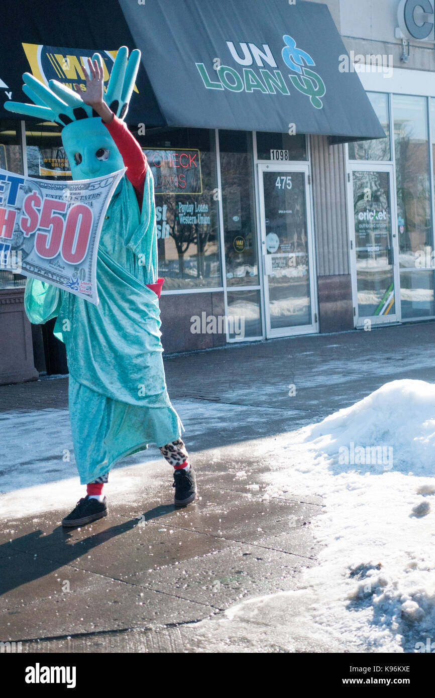 Person in a statue of Liberty costume stands on street corner beckoning the unsuspecting to come in for a loan. St Paul Minnesota MN USA Stock Photo