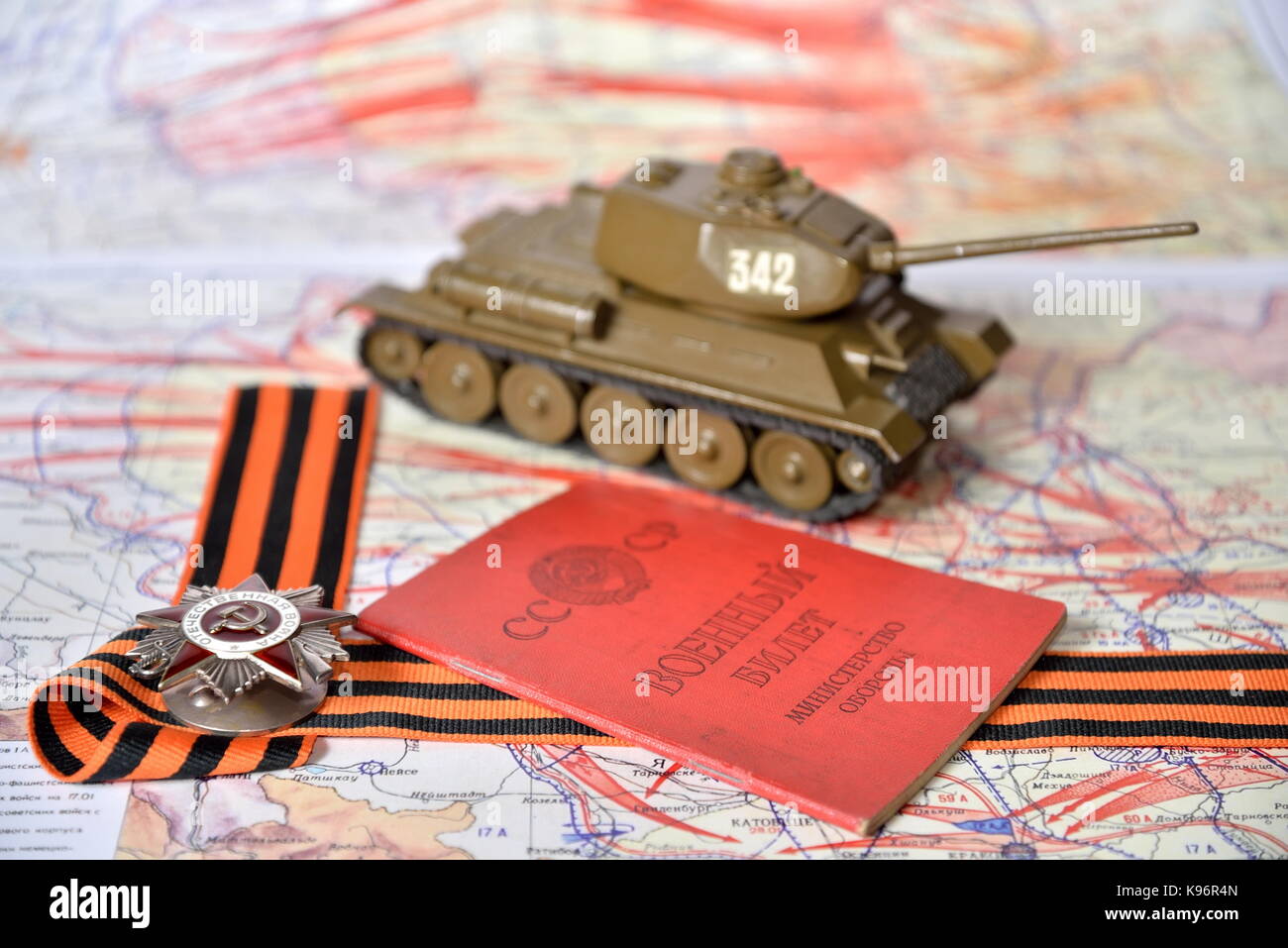 Order of the Patriotic War in St. George's bow, the Soviet military ID and model of the T-34 are in the military card of the liberation of Poland Stock Photo
