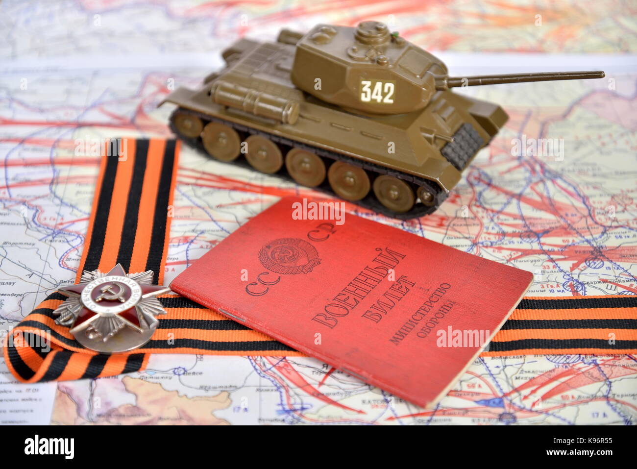 Old military card of the USSR , order of the Patriotic War in St. George's bow and model of the T-34 are in the military card of the liberation of Pol Stock Photo