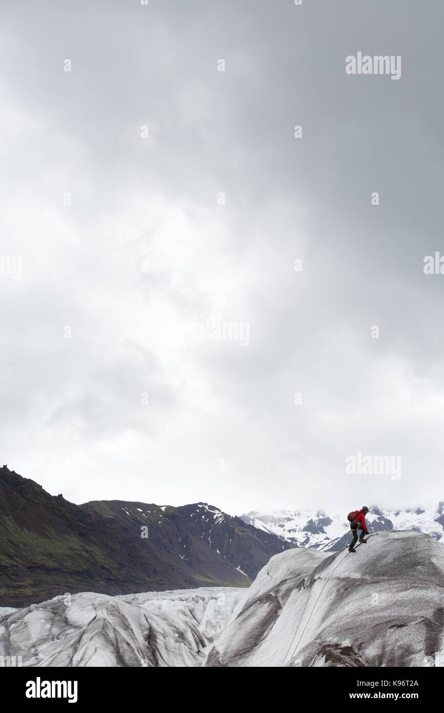 A climber uses ice axes to climb Skaftafell Glacier. Stock Photo