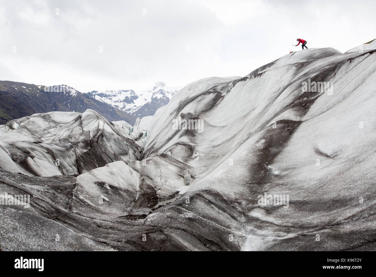 A climber uses an ice axe to climb Skaftafell Glacier. Stock Photo