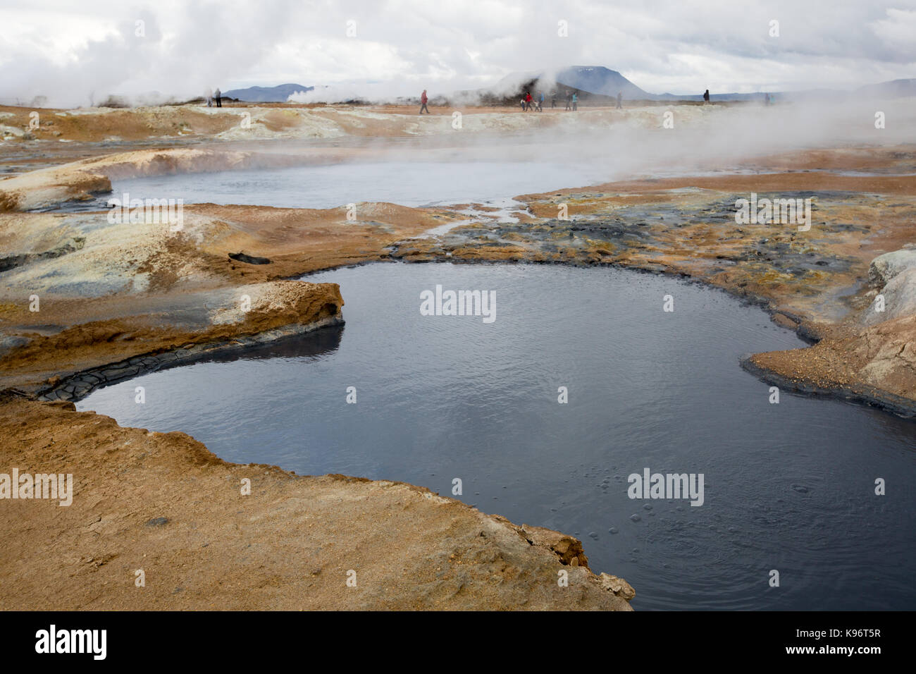 A view of the steaming mud pots geothermal area near Lake Myvatn. Stock Photo