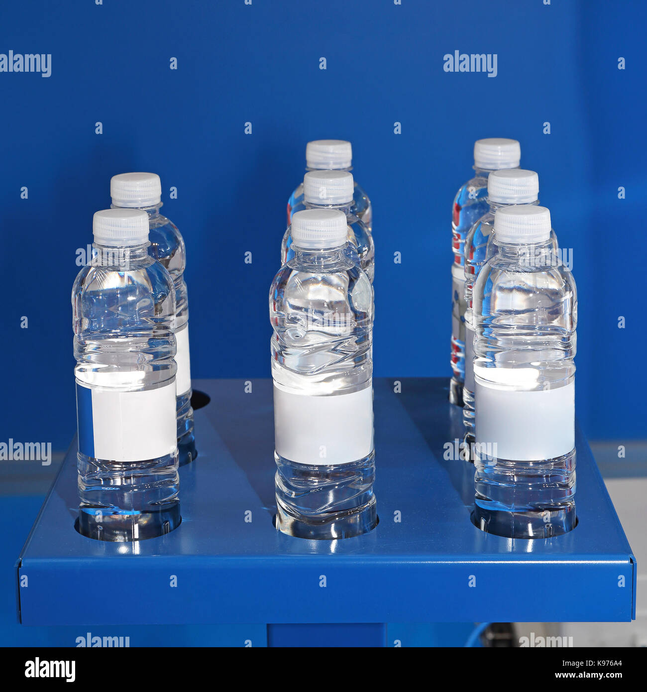 Water in Plastic Bottles at Blue Shelf Stock Photo