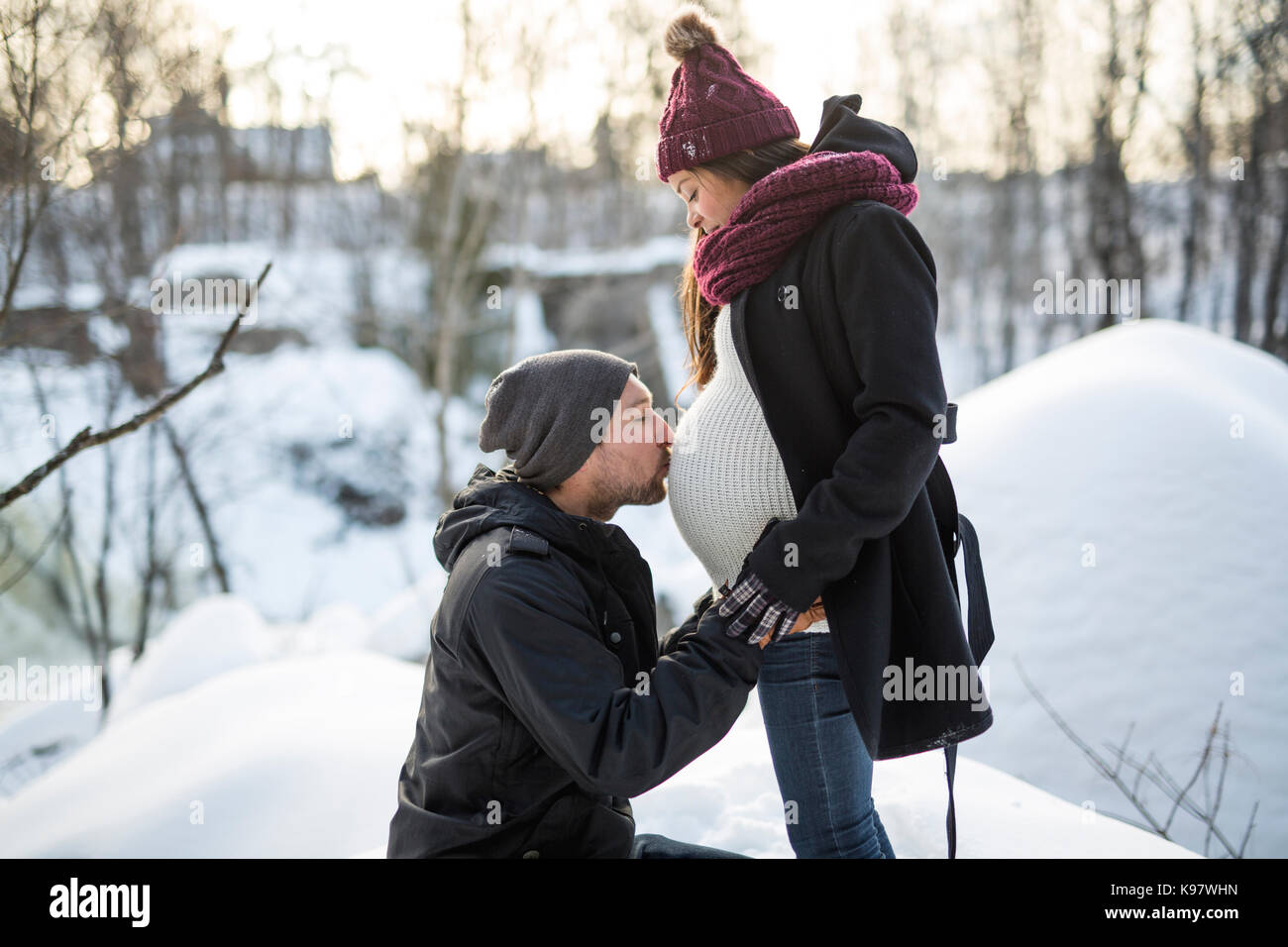 Pregnant couple have fun in winter nature Stock Photo - Alamy