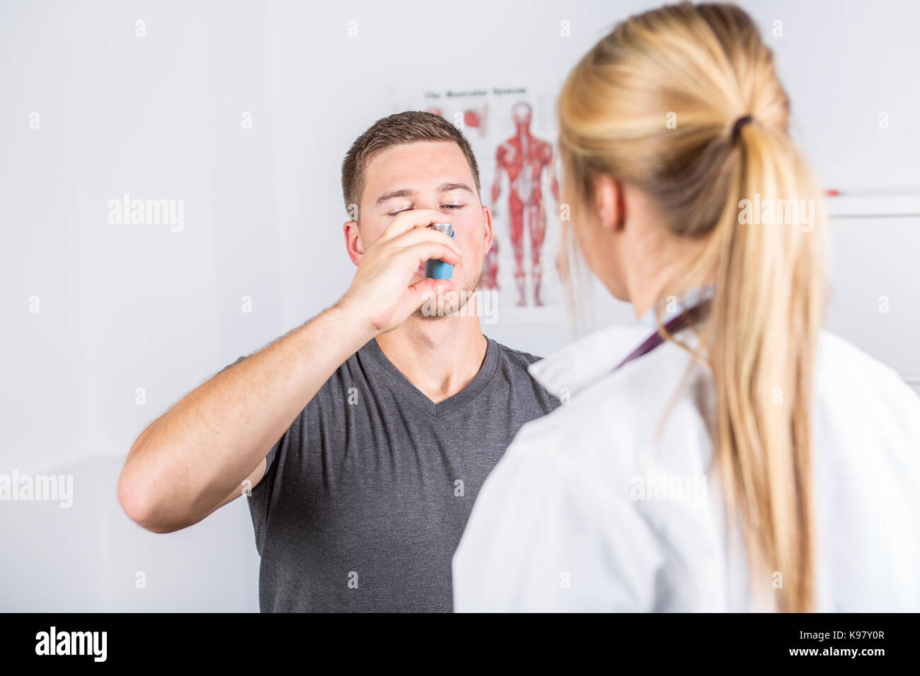 Medical doctor applying oxygen treatment on a sporty men Stock Photo