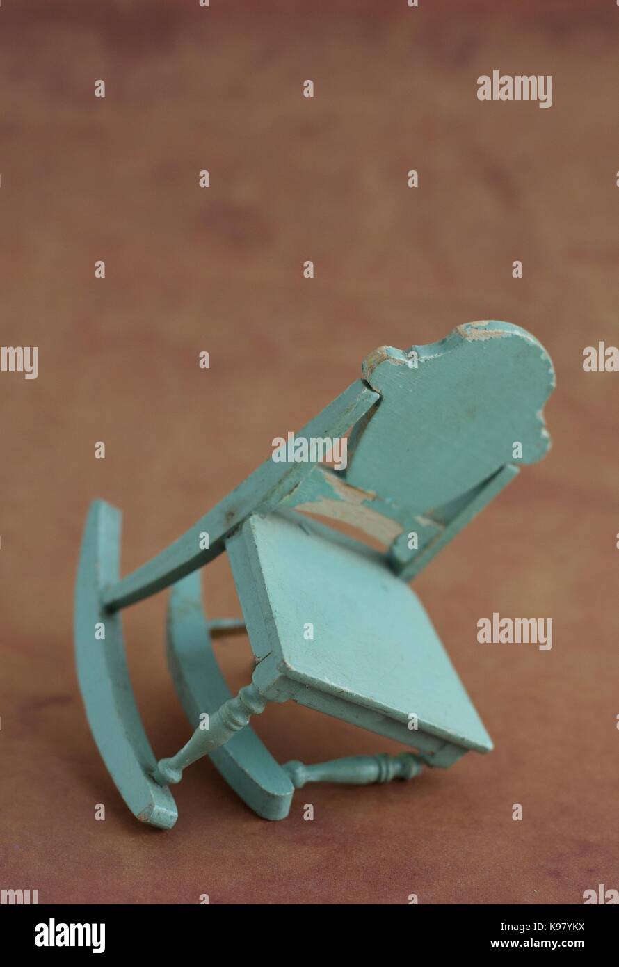 An old fashioned rocking chair with a collapsed leg. Stock Photo