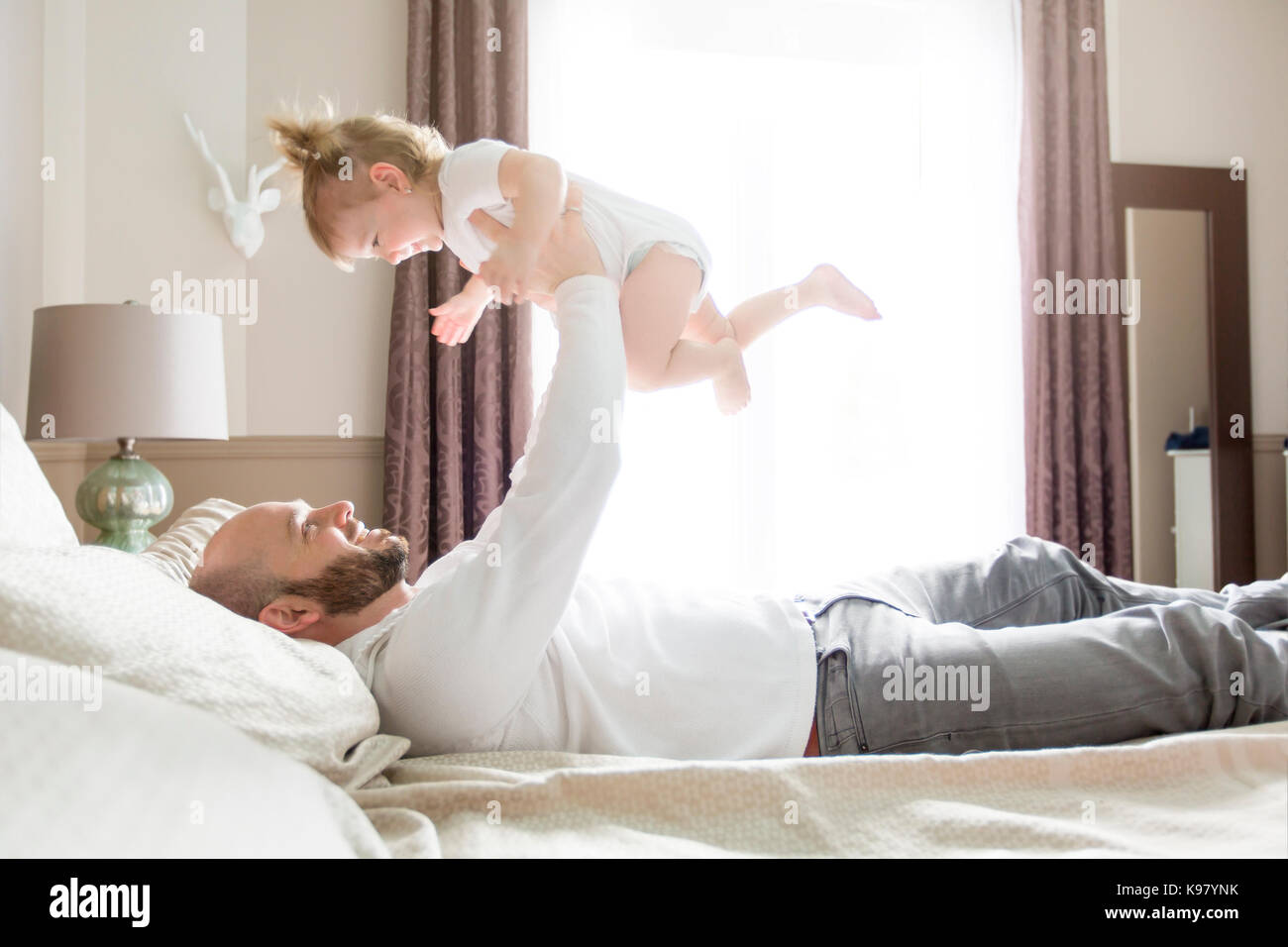 Father with adorable baby toddler on bed Stock Photo Alamy