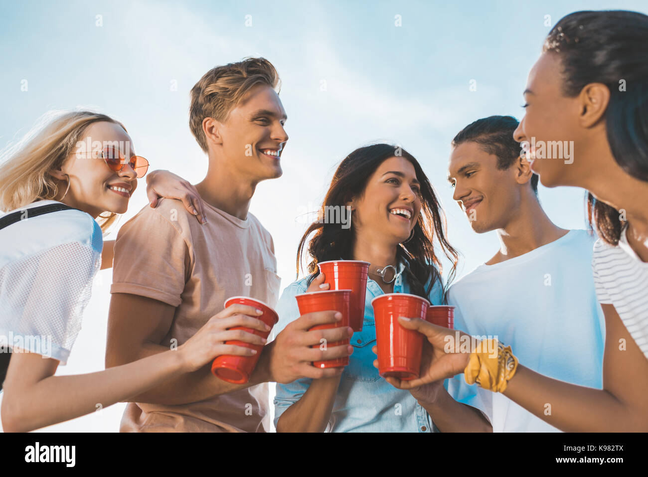 Man woman clinking plastic cups hi-res stock photography and images - Alamy