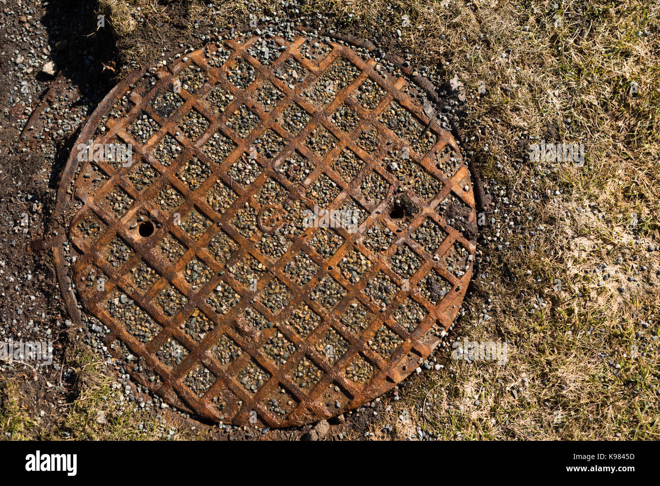 Sewer man hole cover in a street Stock Photo