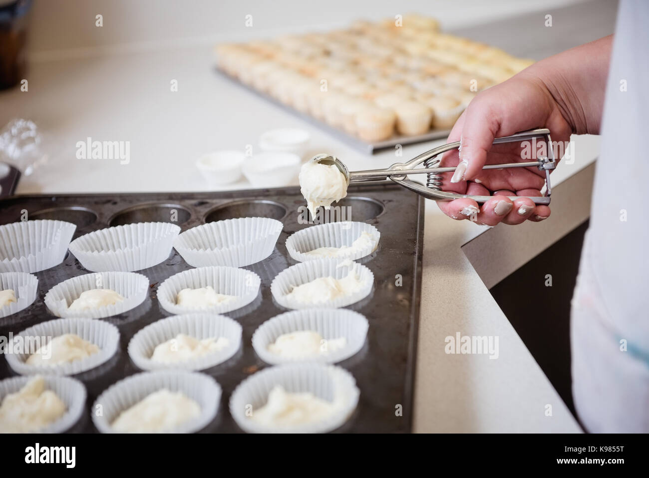 Scooping Batter With Batter Scooper Into Cupcake Pan Lined Stock Photo -  Download Image Now - iStock