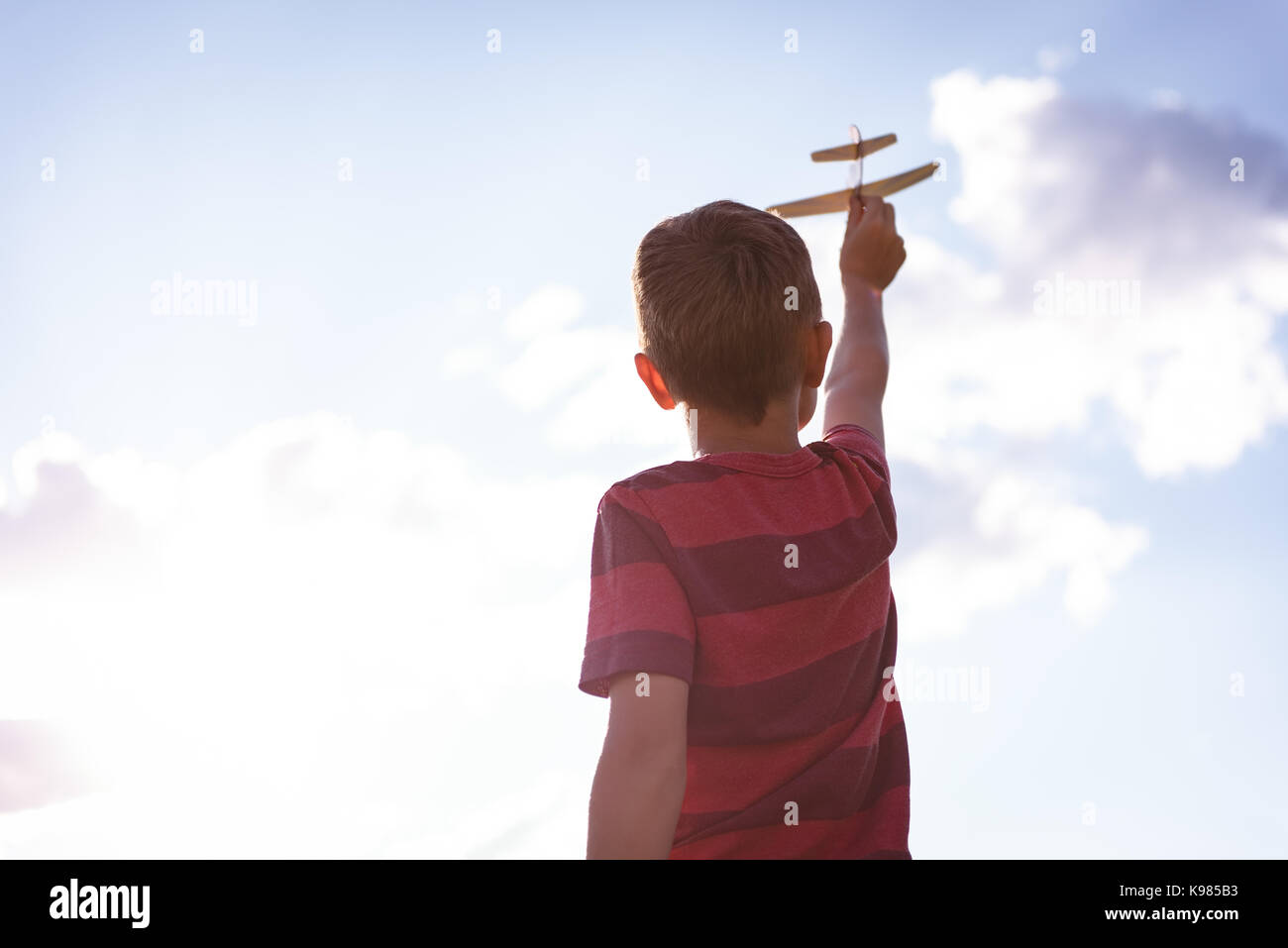 Boy playing with toy aeroplane on a sunny day Stock Photo - Alamy