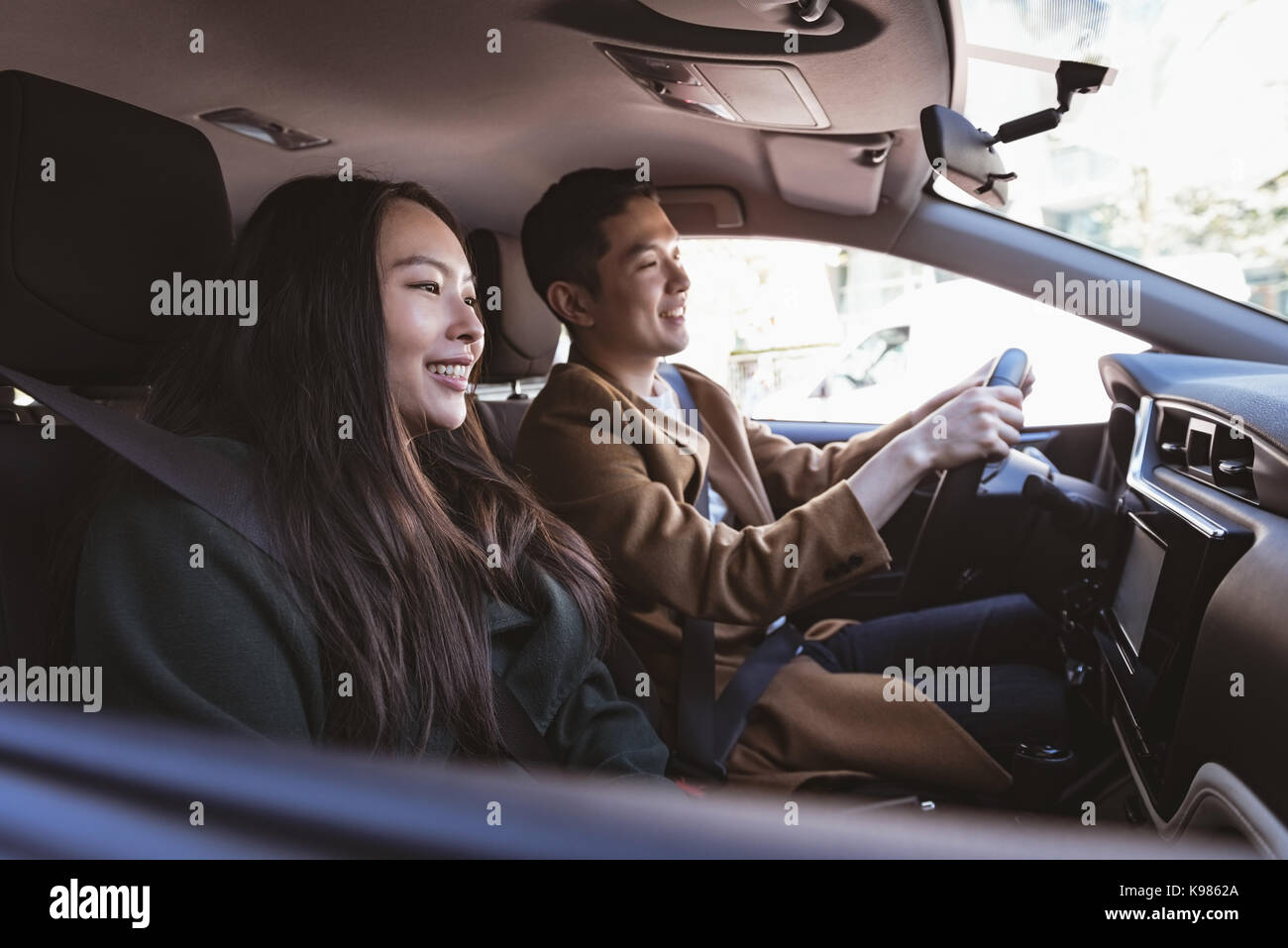 Smiling couple in the car Stock Photo - Alamy