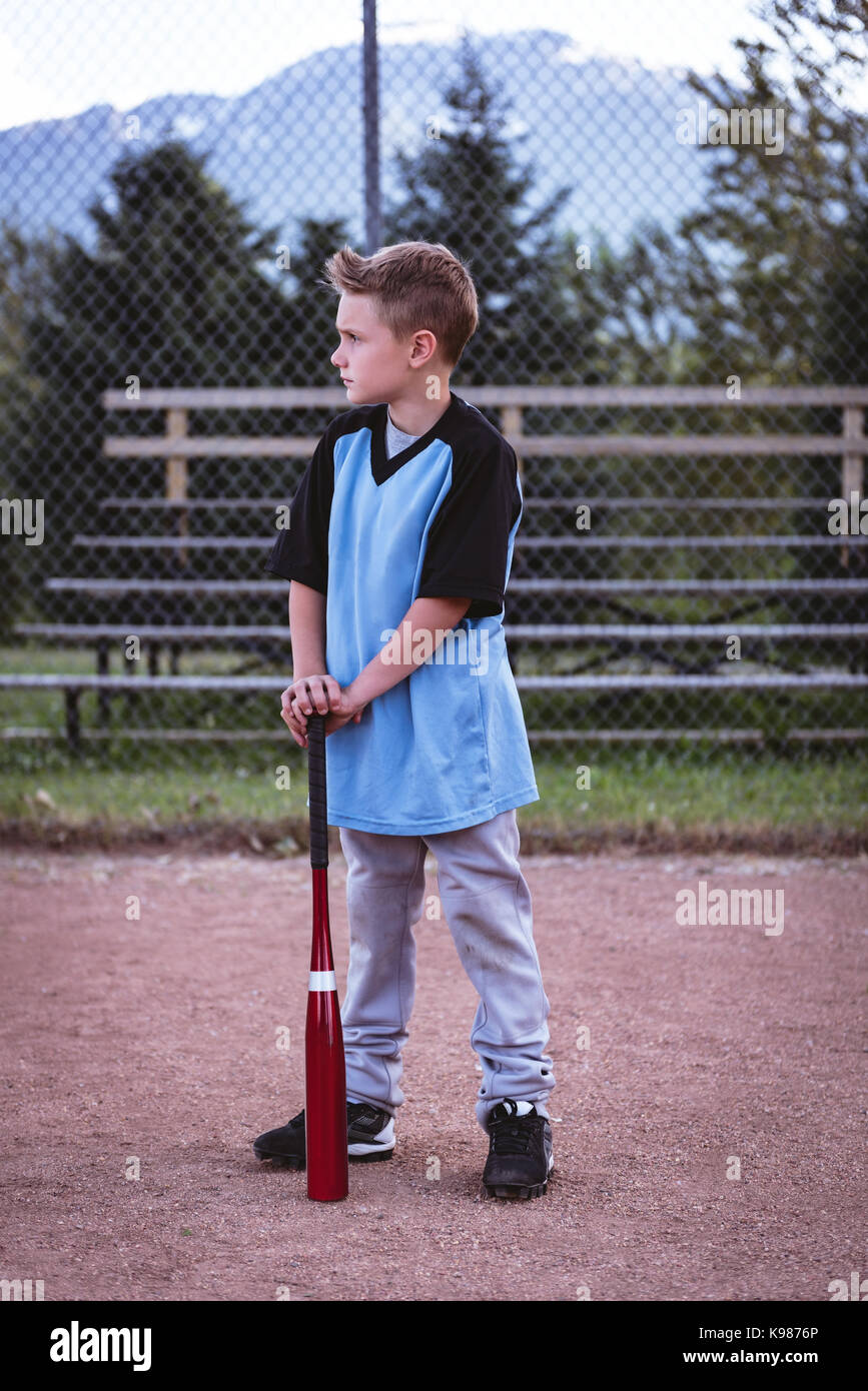 Excited child baseball player focused ready to bat. Kid holding a baseball  bat Stock Photo - Alamy