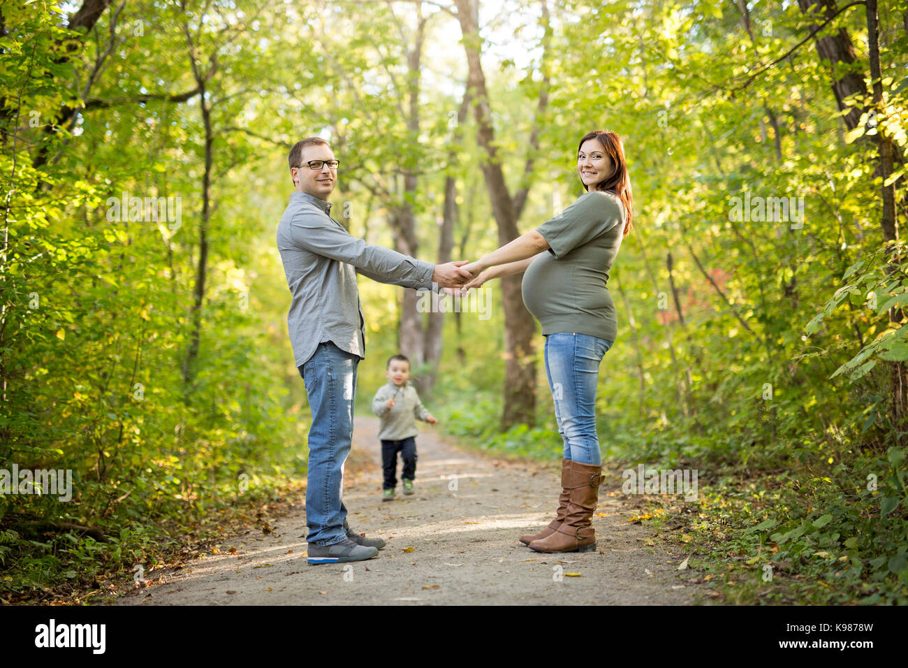 A Beautiful pregnant couple relaxing outside in the park Stock Photo ...