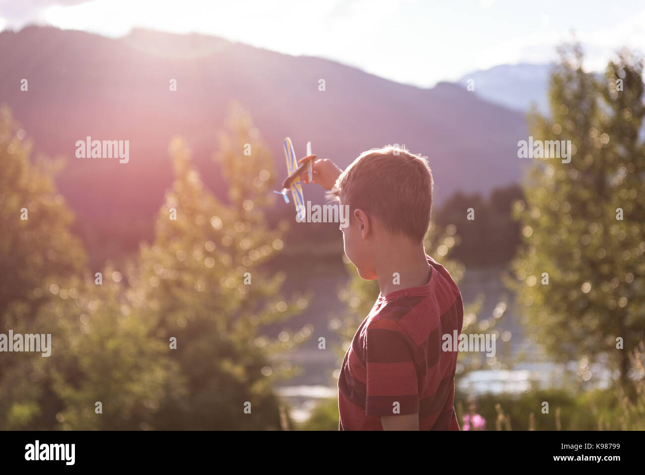 Boy playing with toy aeroplane on a sunny day Stock Photo - Alamy