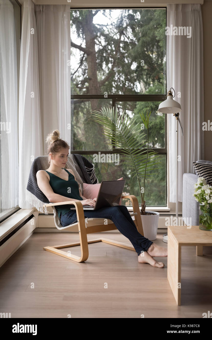 Woman sitting chair full length hi-res stock photography and images - Alamy