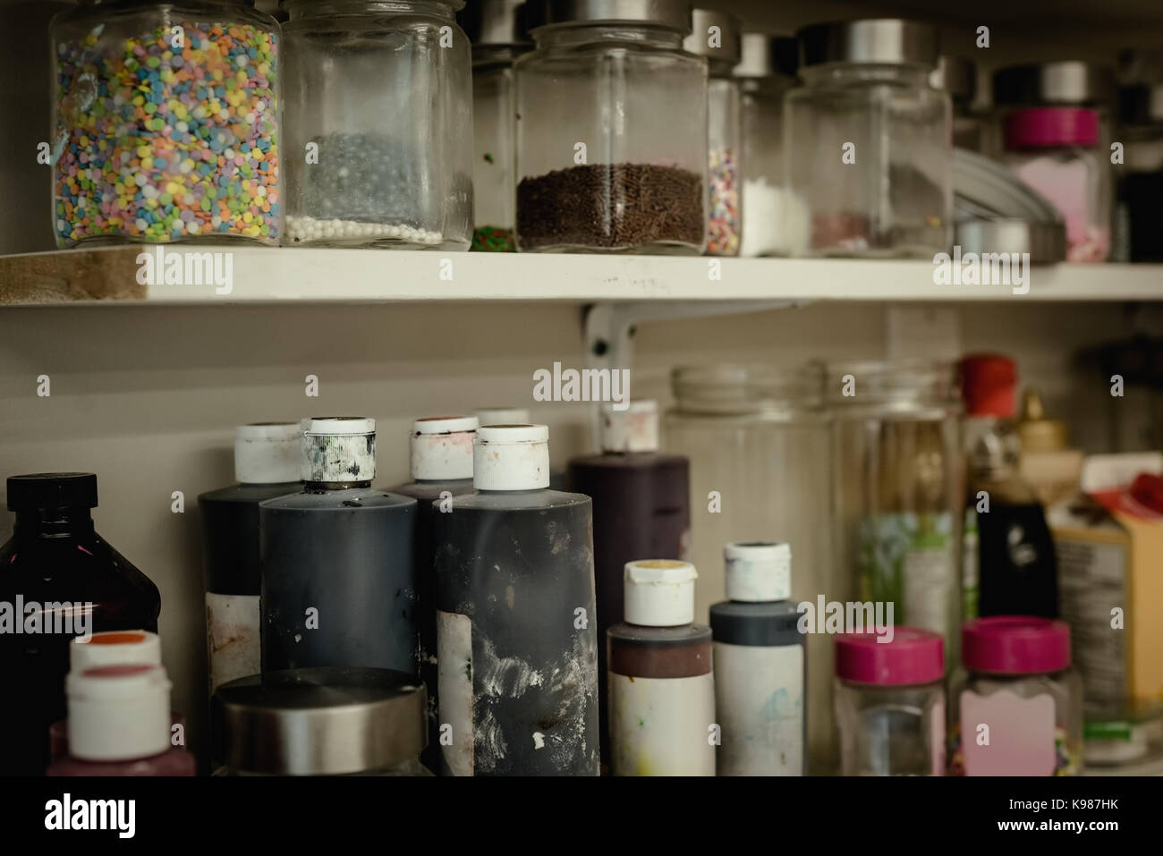 Various ingredient bottles kept in shelf at kitchen Stock Photo
