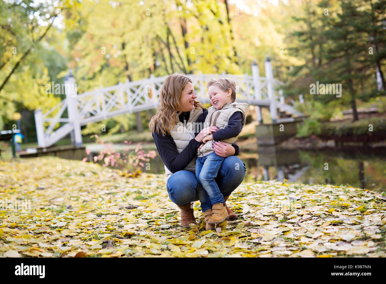 An Adorable little boy with his mother in autumn park Stock Photo - Alamy