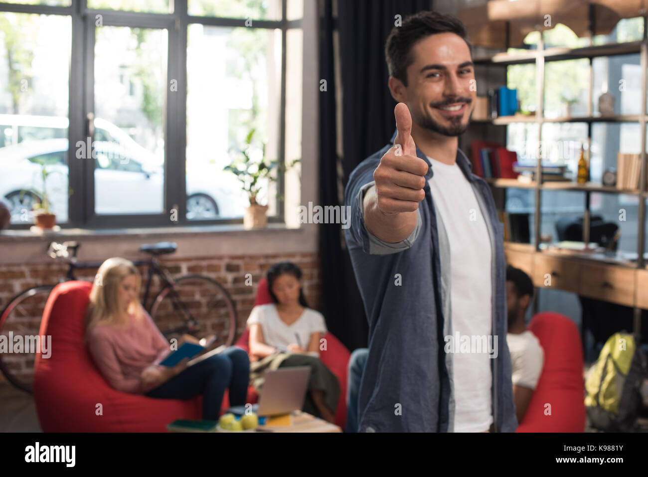 student showing thumb up Stock Photo - Alamy