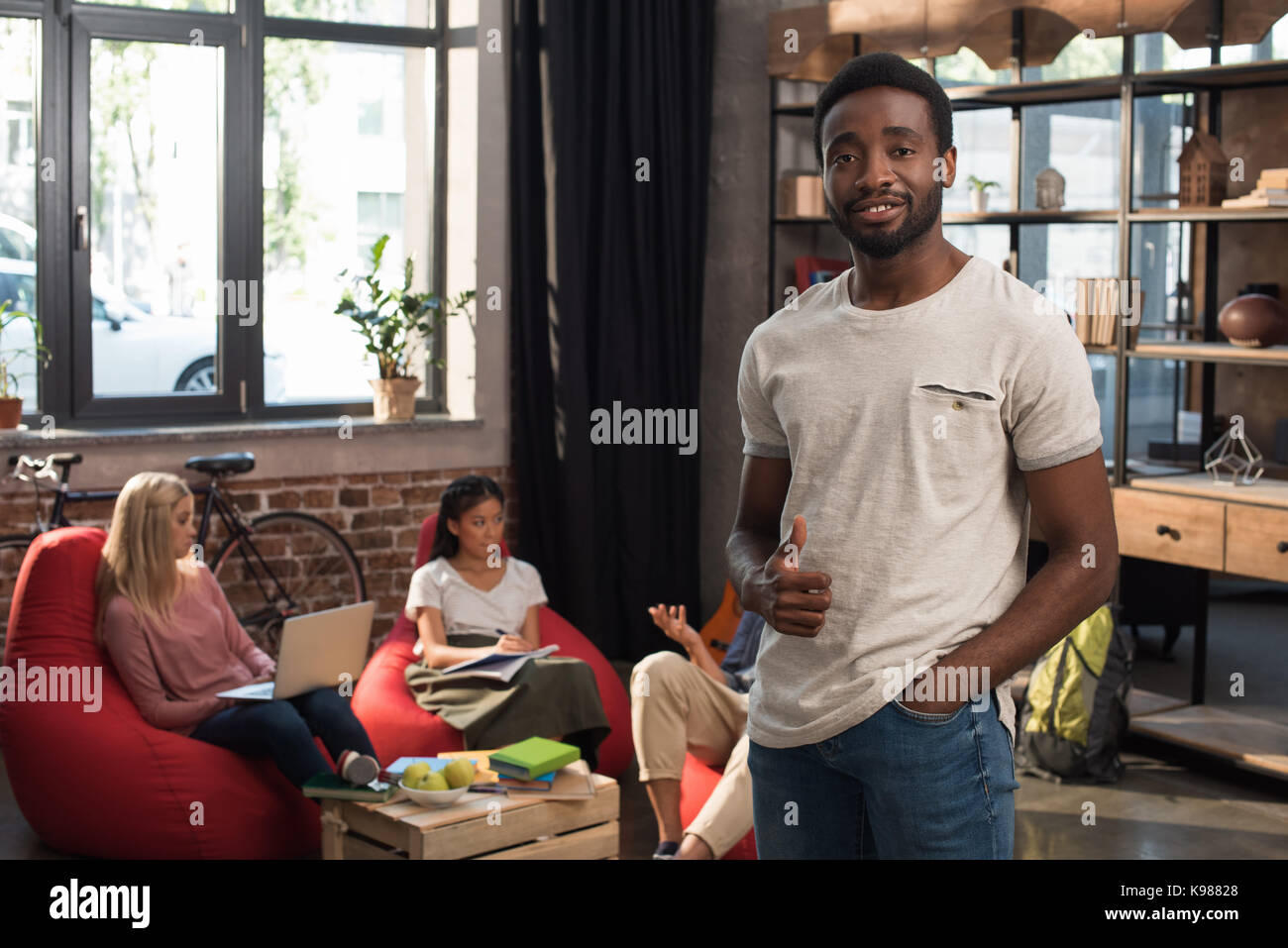 student showing thumb up Stock Photo - Alamy
