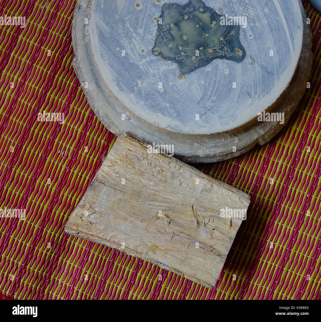 Thanaka wood and Kyauk pyin stone slab. Tanaka is Burmese tradition cosmetic made from bark of tanaka tree. Stock Photo