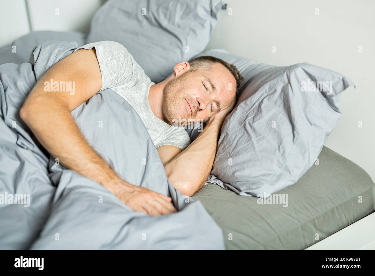 A Portrait of a young man from above sleeping in a bed Stock Photo Alamy
