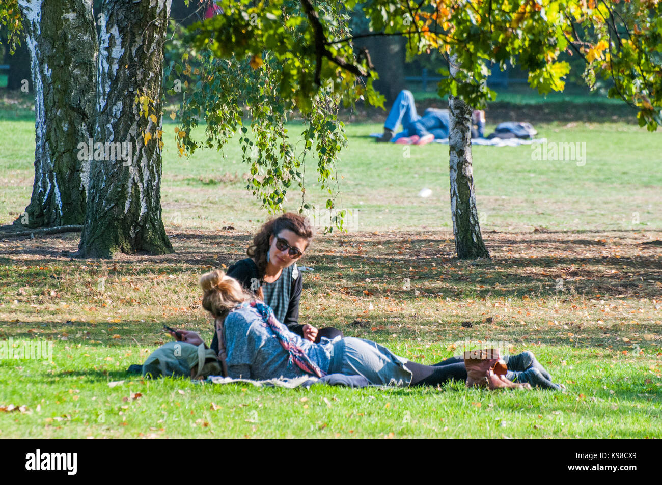 Friends relaxing on the lawns of the Tiergarten, Berlin Stock Photo