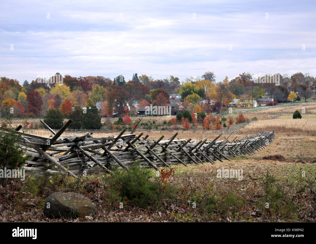 Gettysburg National Military Park Pennsylvania, USA - October 31, 2016 - Battlefield View of Split Rail Fence with Autumn Leave and Town in Background Stock Photo