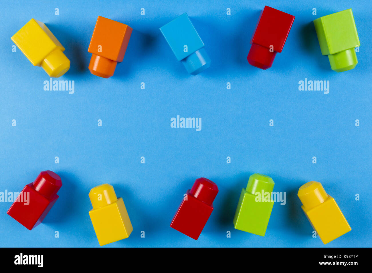 Colorful plastic construction blocks on blue background Stock Photo - Alamy