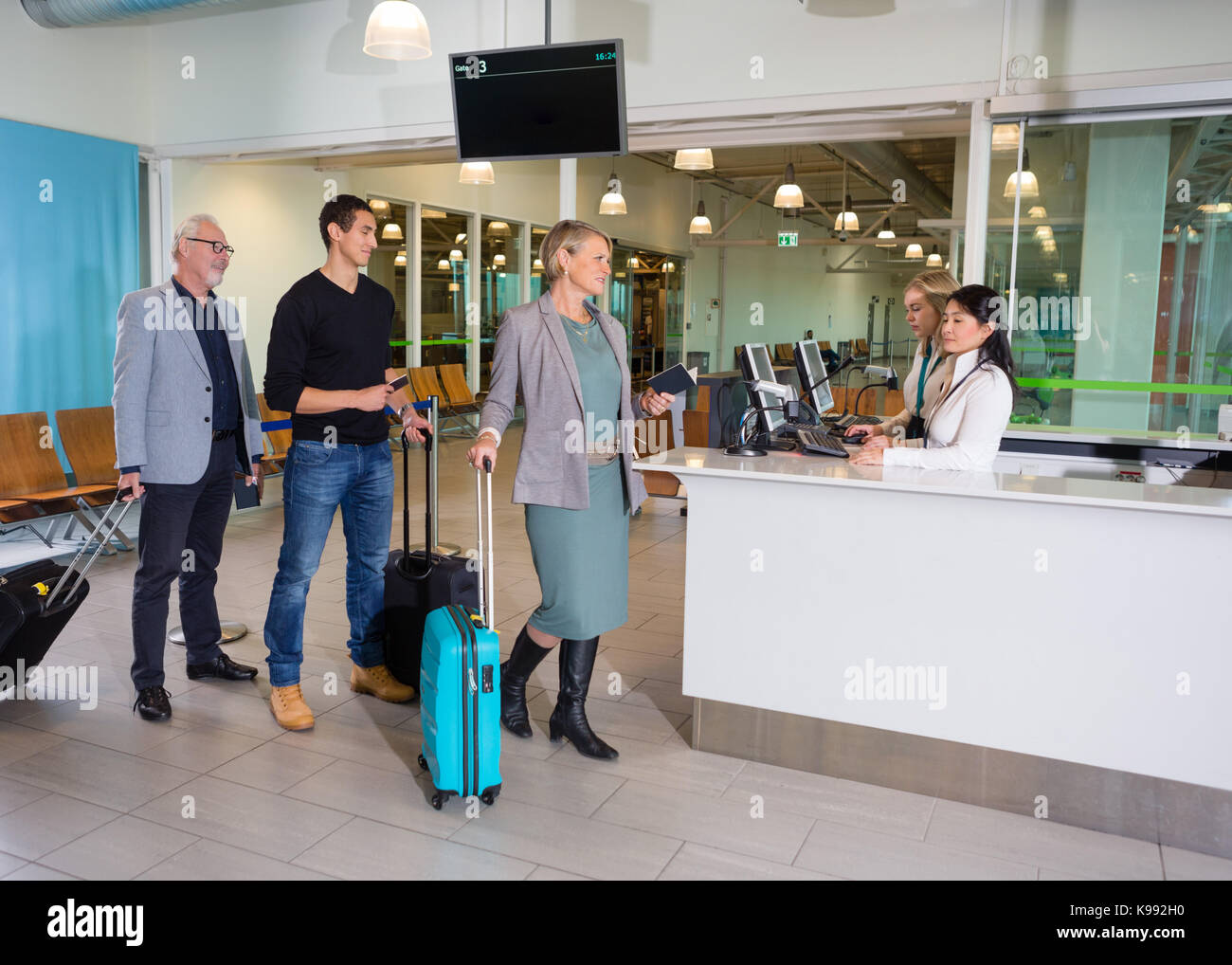 Passengers With Luggage Waiting At Airport Reception Stock Photo