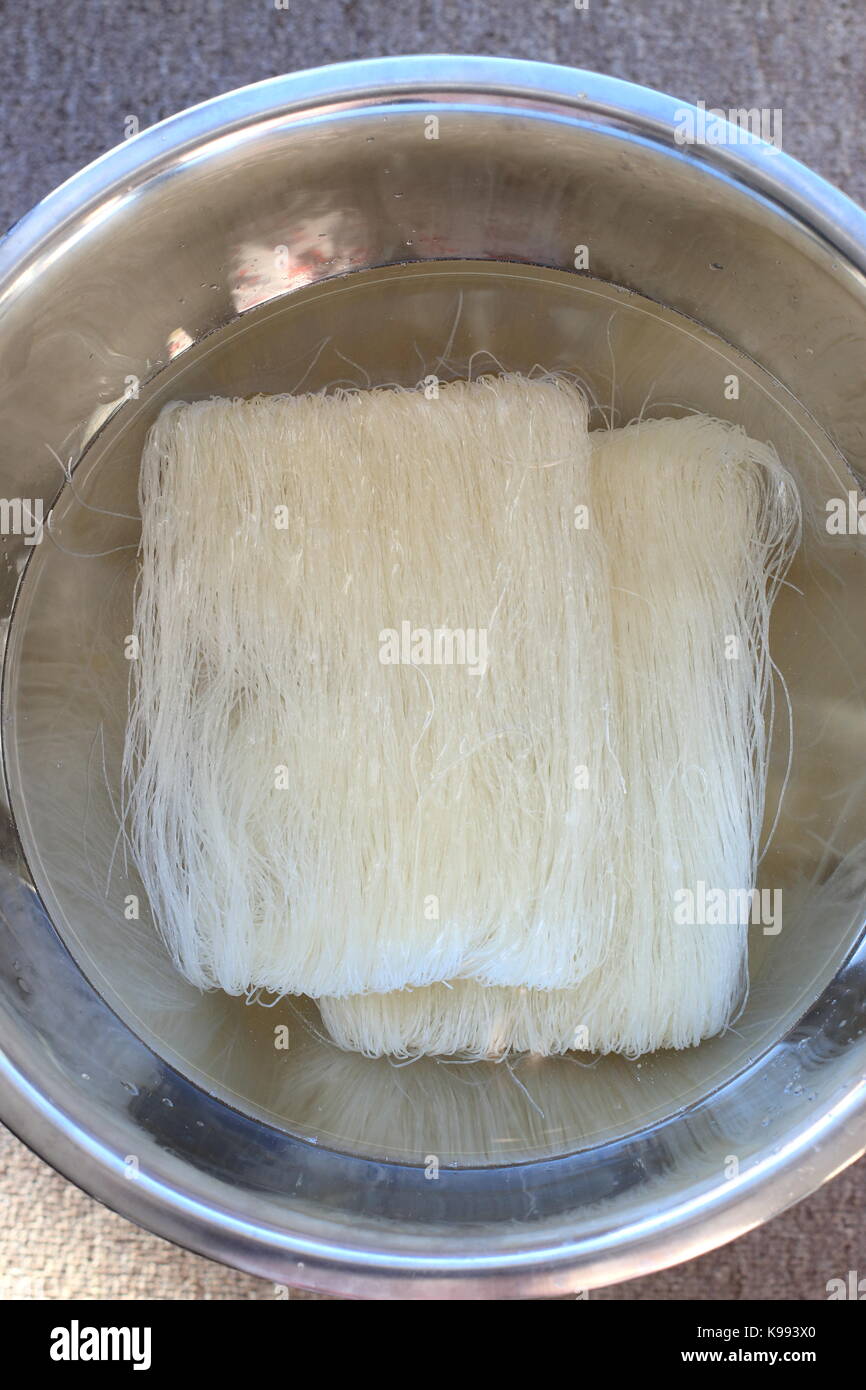 Soaking Rice vermicelli noodles before cooking Stock Photo