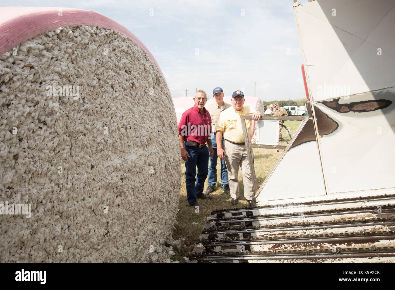El Campo, USA. 21st Sep, 2017. U.S. Secretary of Agriculture Sonny Perdue (yellow shirt) and House Agriculture Chairman Mike Conaway (tan) tour cotton farms ravaged by Hurricane Harvey three weeks ago. In red shirt is cotton buyer Johnny Ropolo. Credit: Bob Daemmrich/Alamy Live News Stock Photo