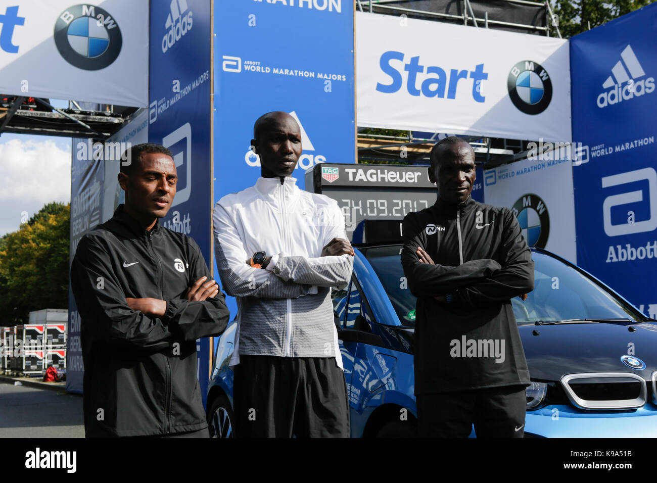 Kenenisa Bekele from Ethiopia, Eliud Kipchoge from Kenya and Wilson Kipsang from Kenya pose for the cameras at the starting line.  The leading male and female runners for the 44th BMW Berlin Marathon as well as two Guinness Worlds Records contestants posed for the cameras at the starting line of the marathon. Stock Photo