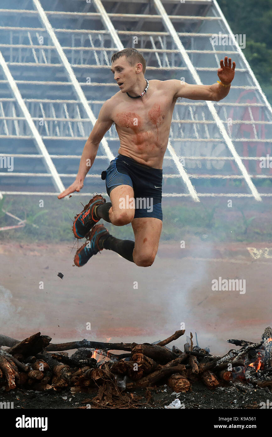 Rizal Province, Philippines. 23rd Sep, 2017. A participant jumps over burning wood as he competes during the Spartan Race 2017 in Rizal Province, the Philippines, Sept. 23, 2017. Credit: Rouelle Umali/Xinhua/Alamy Live News Stock Photo