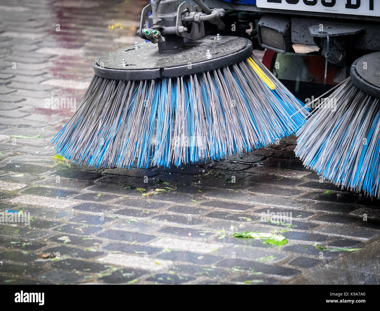 Street Sweeping Machine Brushes - a Street Sweeper pauses after clearing up debris in London's Soho after the market closes Stock Photo