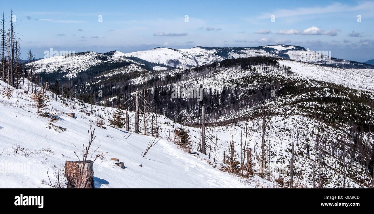 winter Silesian Beskids mountains in Poland with Skrzyczne and other hills, snow and blue sky from hiking trail near Barania Gora hill Stock Photo