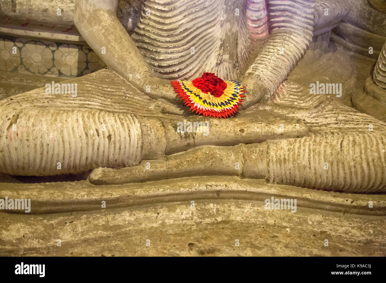 Dambulla Sri Lanka Dambulla Cave Temples - Cave II  Maharaja Viharaya Close Up Of Statue Of Seated Buddha Showing Dhyana Mudra Gesture Of Meditation Holding Flower Offering In Hands Stock Photo