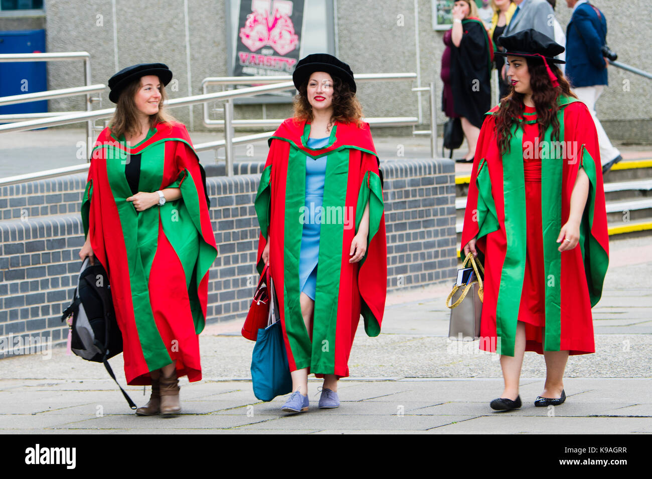 Higher Education in the UK: Three women PhD Doctorol Aberystwyth University students wearing traditional academic gowns and mortar boards  on their graduation day, July 2017 Stock Photo