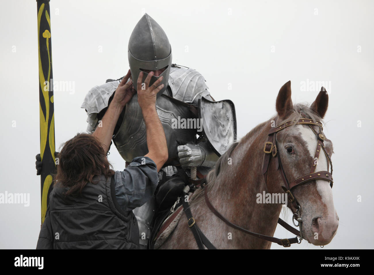 Staff member fixes medieval armour on Czech actor Michal Bednář dressed as a medieval knight during the filming of the new German film 'Die Ritter' ('The Knights') directed by Carsten Gutschmidt by order of ZDF in Milovice in Central Bohemia, Czech Republic in 23 October 2013. Stock Photo