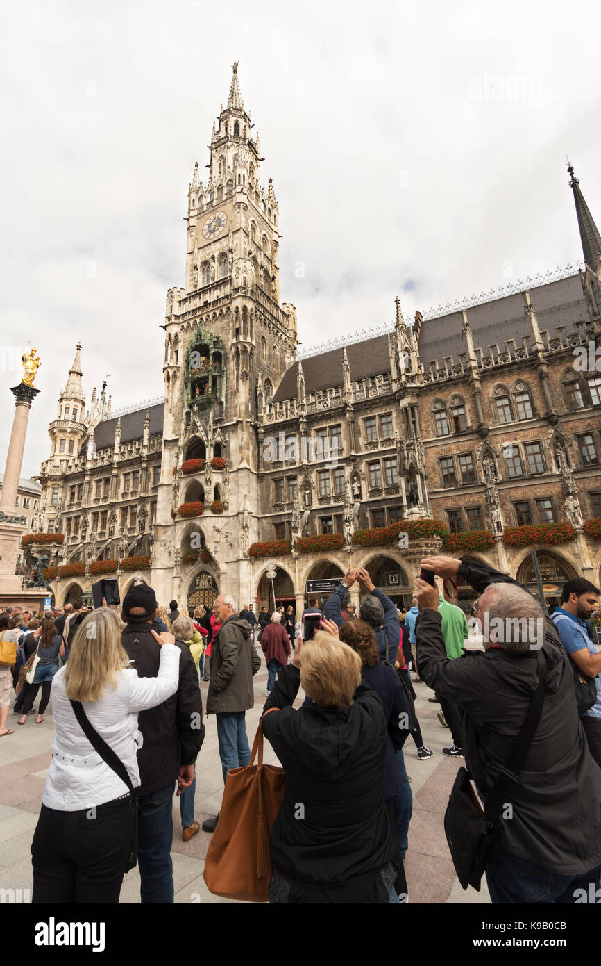 People taking photos of the Rathaus-Glockenspiel, Munich, Germany, Europe Stock Photo