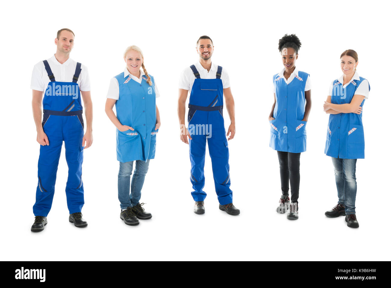 Full length portrait of confident multiethnic janitors standing in row