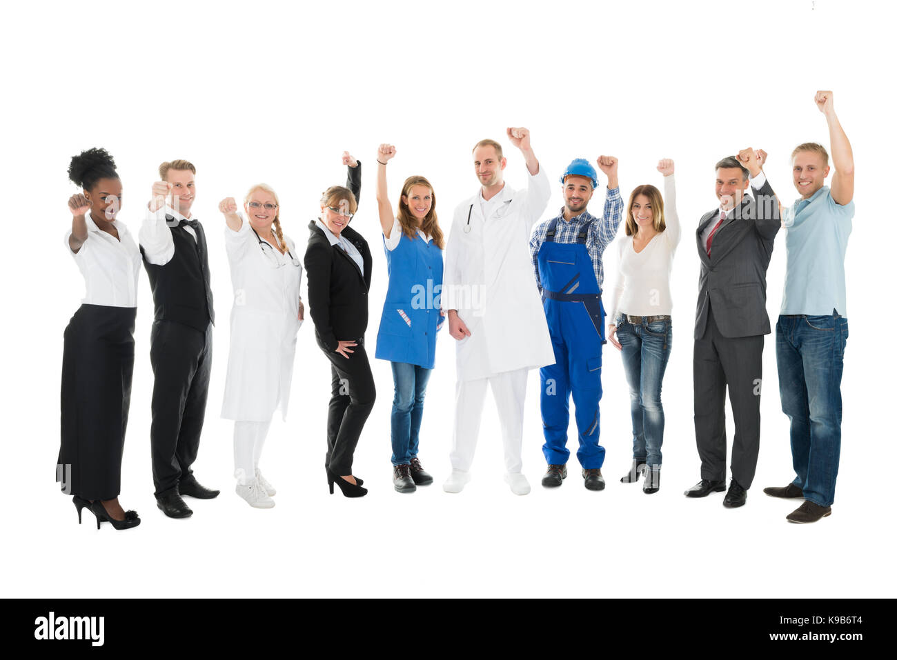 Full length portrait of people with various occupations cheering against white background Stock Photo