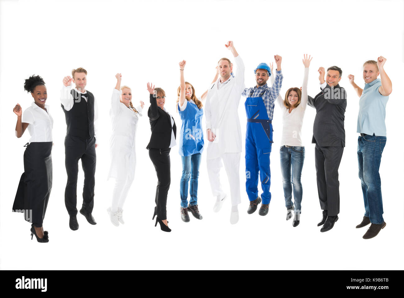 Full length portrait of people with various occupations cheering against white background Stock Photo