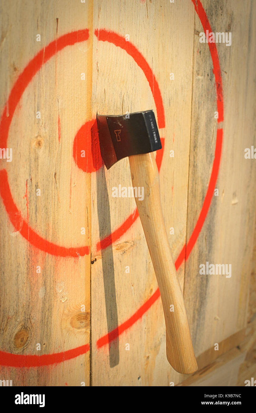 Axe stuck in a wooden target Stock Photo