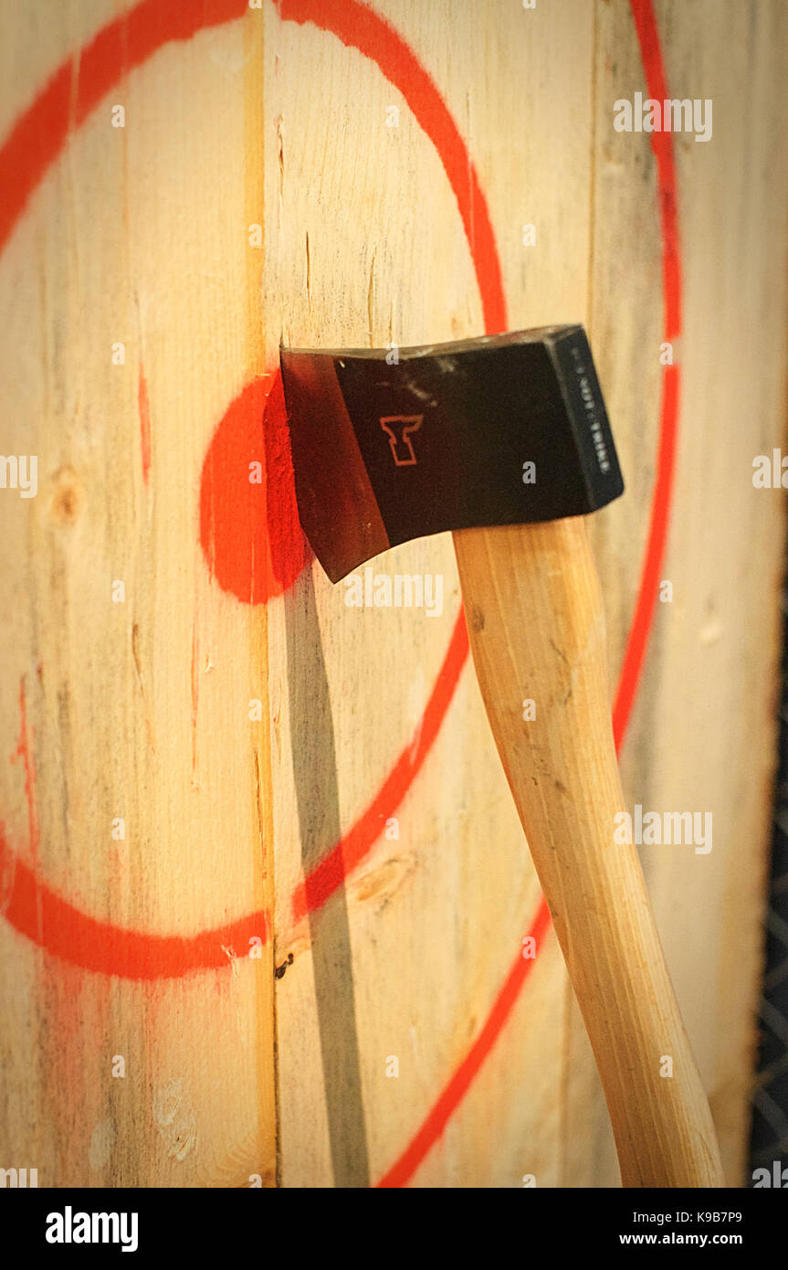 Axe stuck in a wooden target Stock Photo