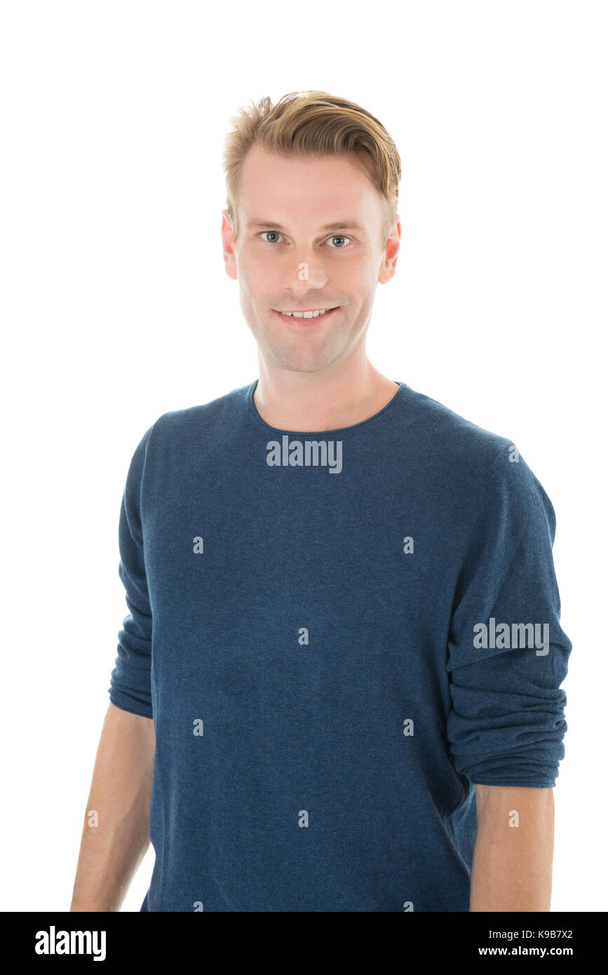 Portrait of smiling man in casuals standing against white background Stock Photo