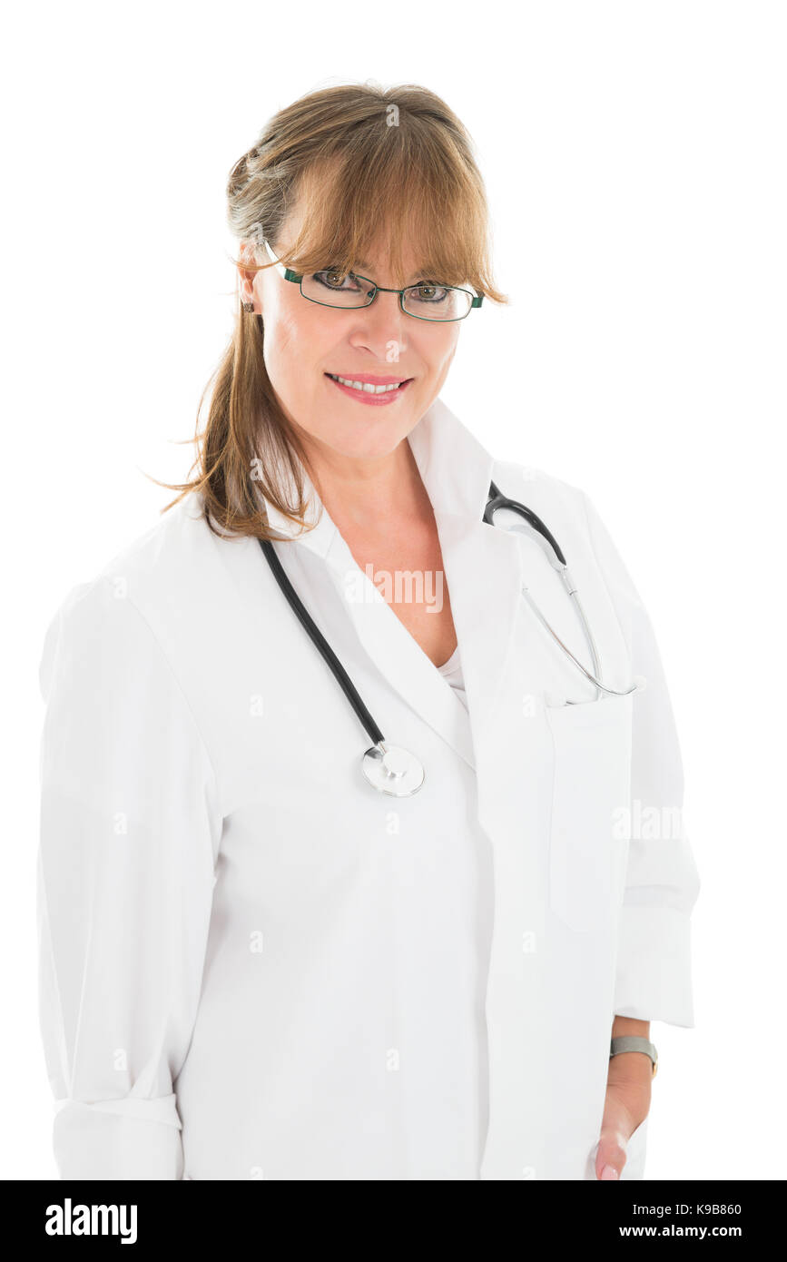 Portrait of smiling female doctor standing against white background Stock Photo