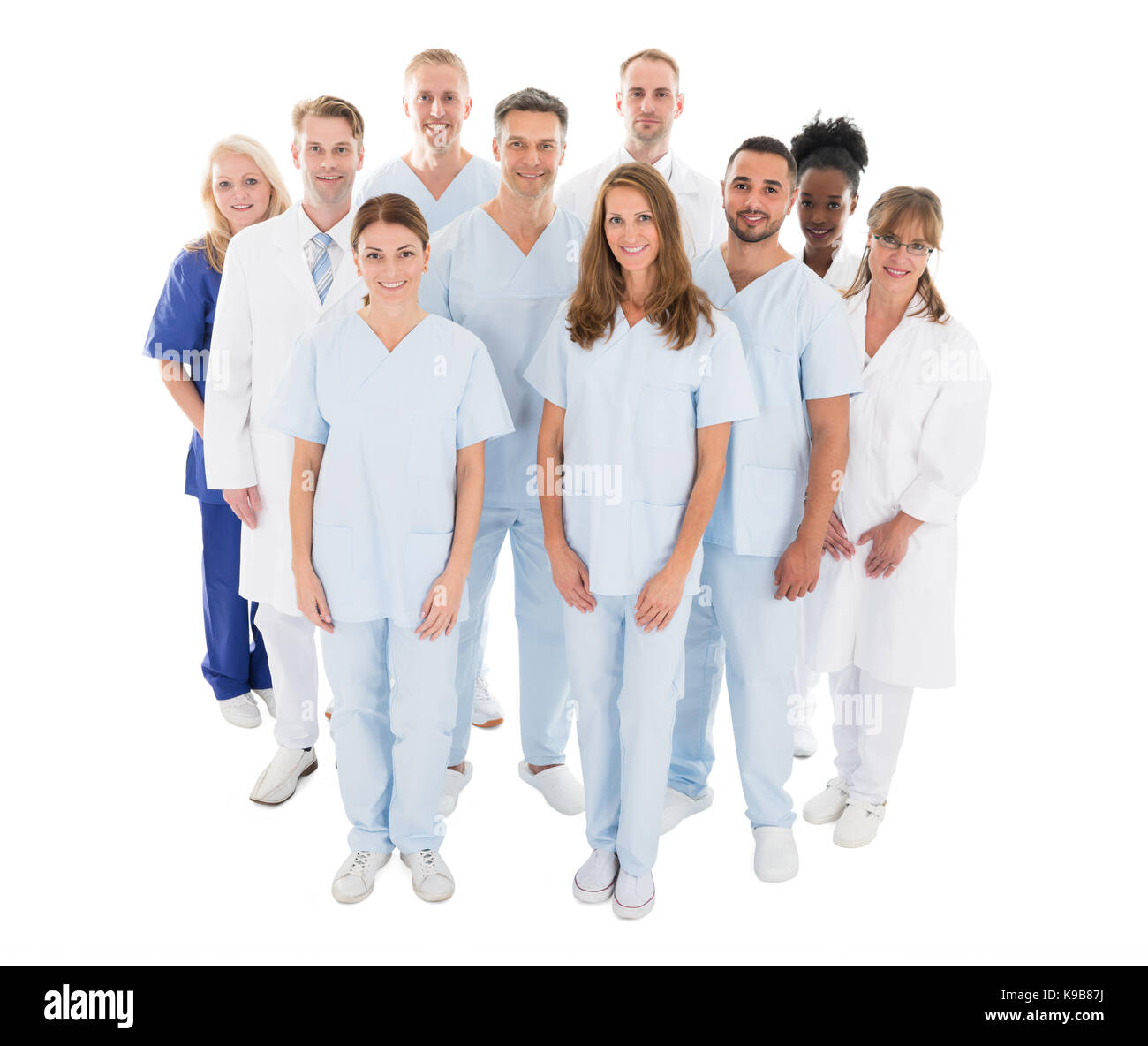 Portrait of happy multiethnic medical team standing against white background Stock Photo